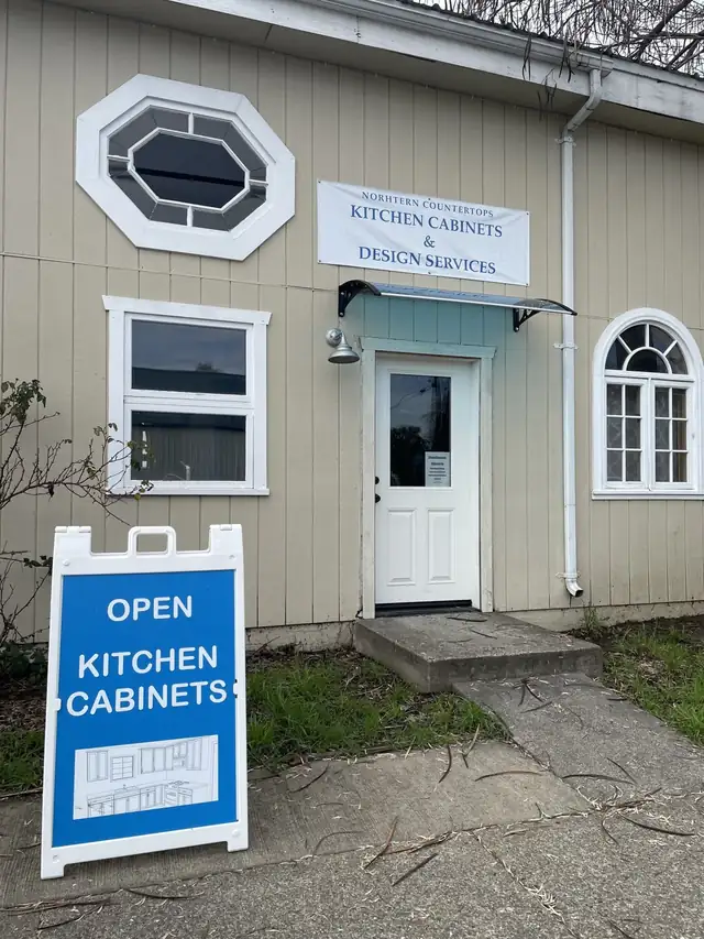 Shop entrance in Ukiah with a Kitchen Cabinets and Design Services banner and an Open sign