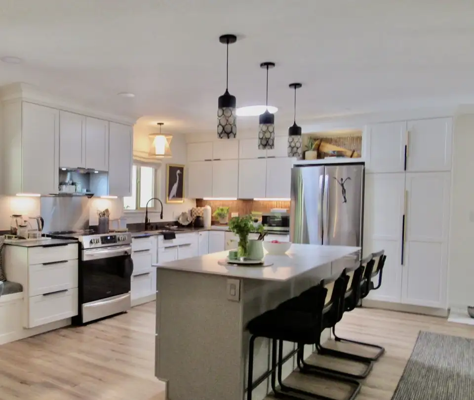 Kitchen cabinets in Ukiah: white shaker kitchen with grey island, black pendant lights and stainless appliances